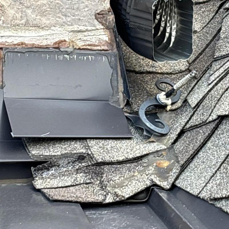 Asphalt shingles with hail damage near roof vent