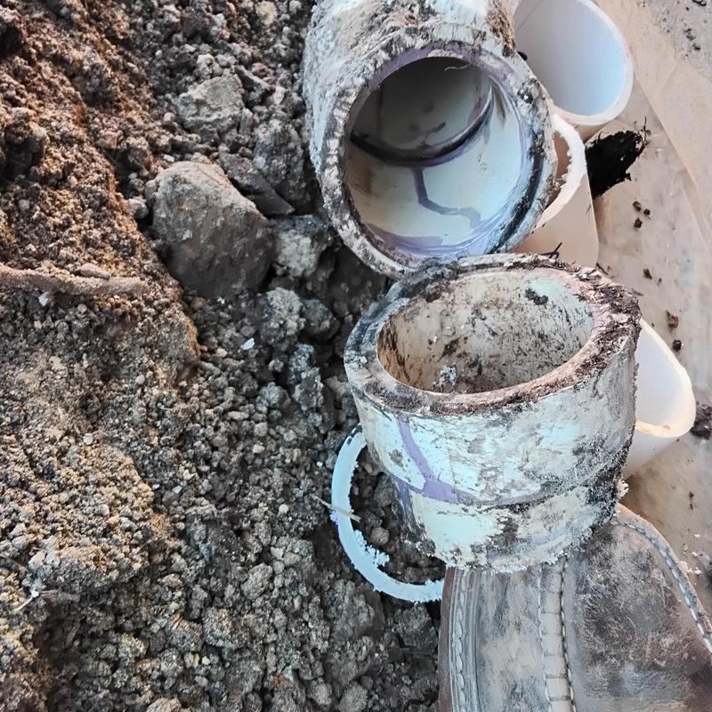 3-inch PVC sewer line with open joint in soil excavation