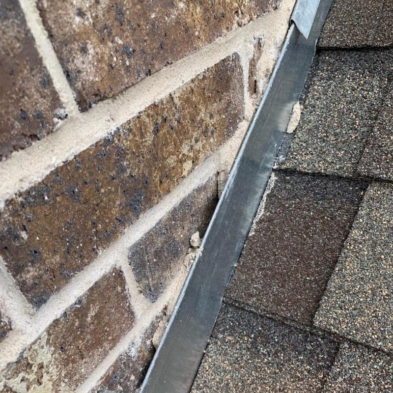 Roof counter flashing missing along brick wall