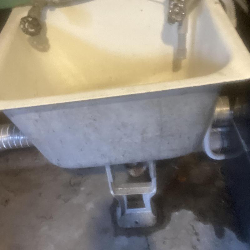 Garage utility sink with faucet and drain pipe