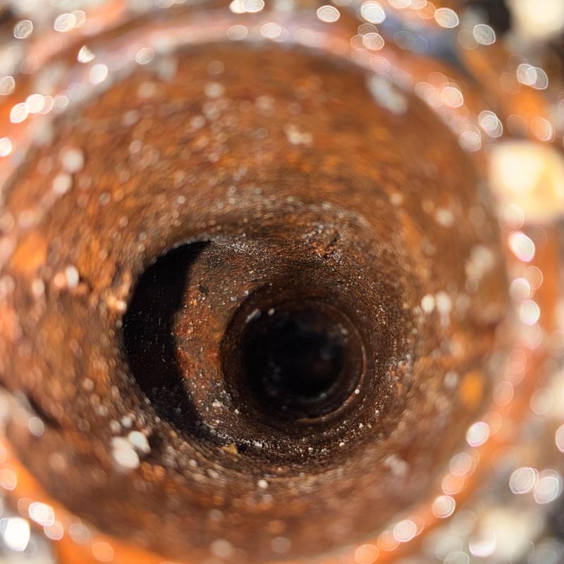 Corroded interior of plumbing pipe close-up view