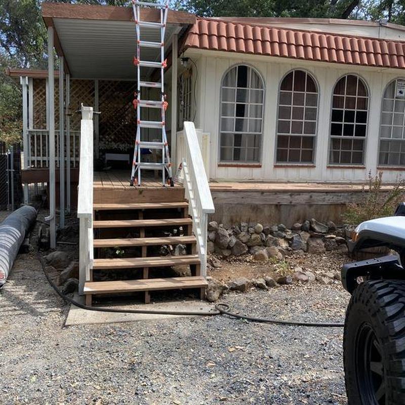 Wooden exterior stairs with white railing and ladder Wooden exterior stairs with white railing and ladder