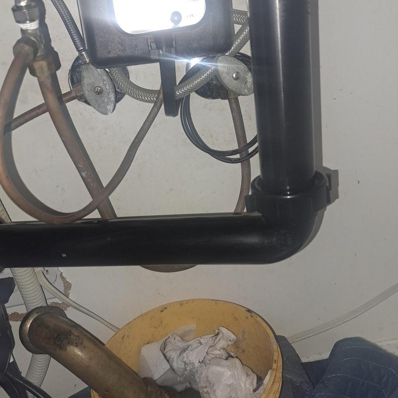 Kitchen sink drain pipes with replaced sections and tools Kitchen sink drain pipes with replaced sections and tools