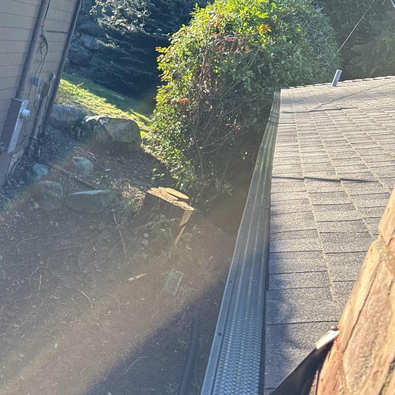 Gutter guard installed along residential roof edge