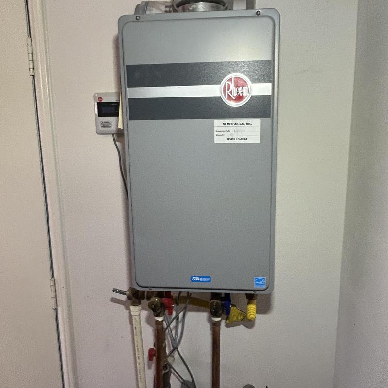 Rheem tankless water heater with new brackets installed