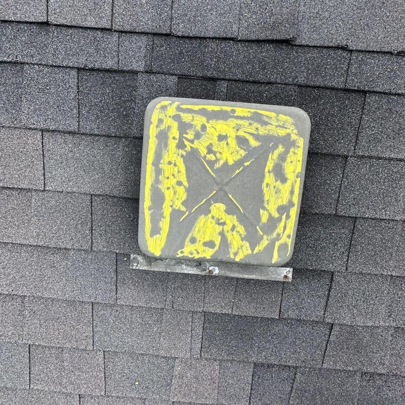 Roof vent with marked hail damage on shingles
