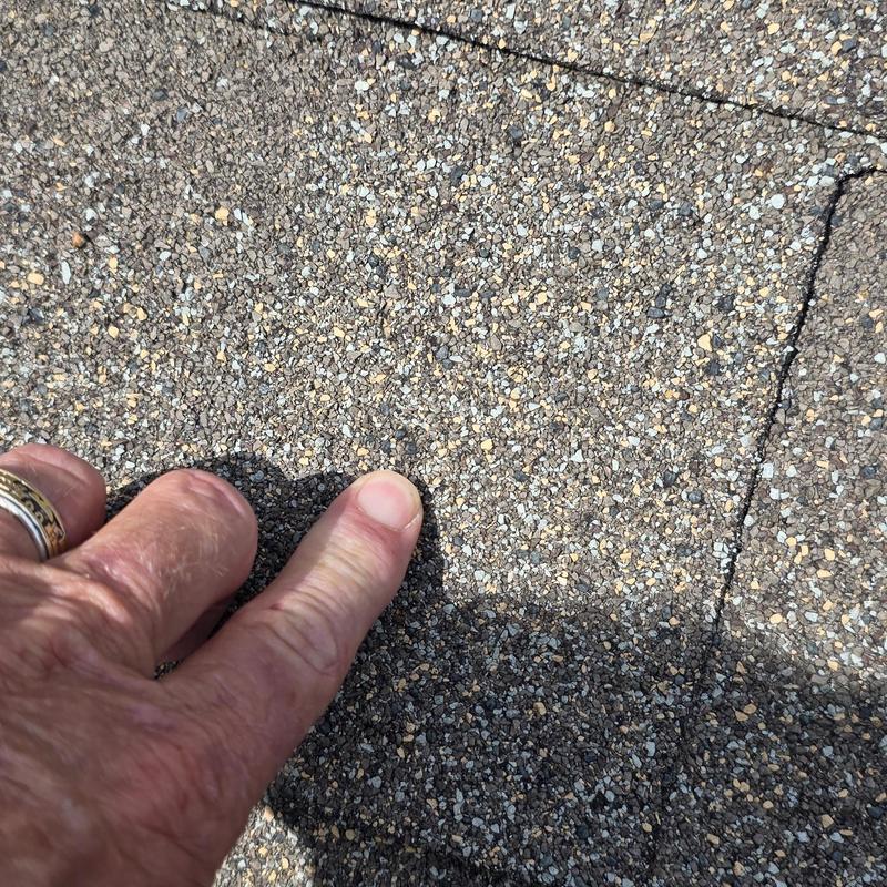 Asphalt shingle granule loss from hail damage close-up