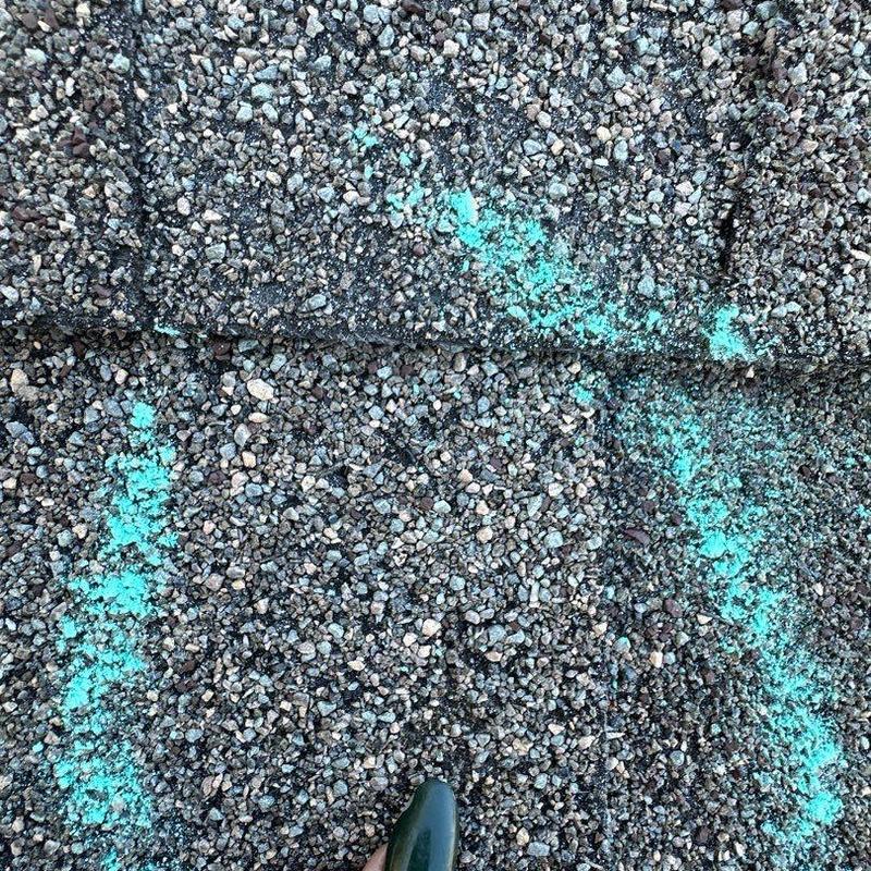 Asphalt shingle roof with chalk marks for damage assessment Asphalt shingle roof with chalk marks for damage assessment
