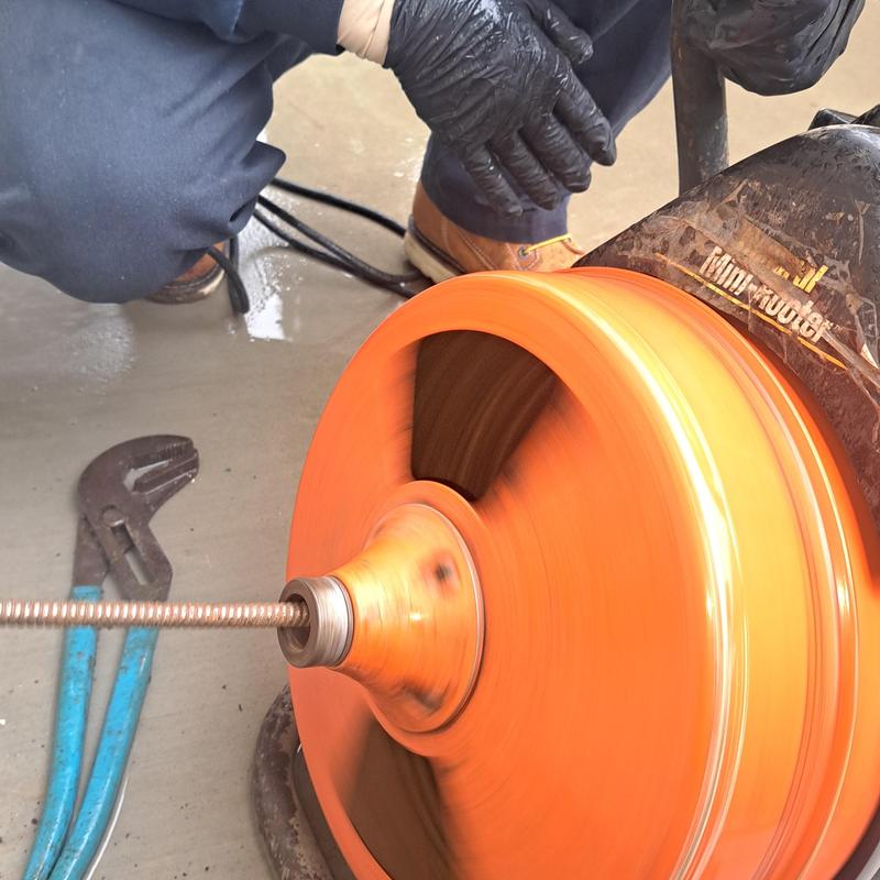 Kitchen drain snake clearing with mini jetter tool Kitchen drain snake clearing with mini jetter tool