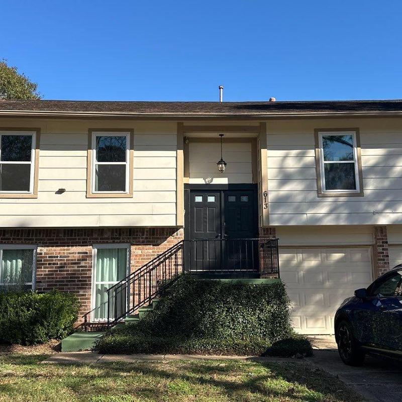 Roof shingles with wind damage on residential home Roof shingles with wind damage on residential home