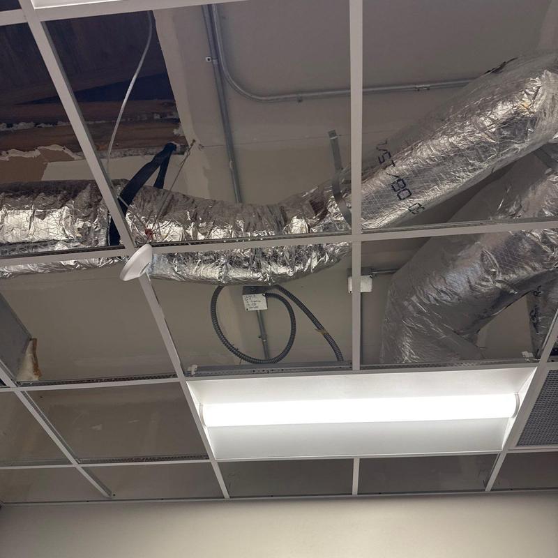 HVAC ductwork in suspended ceiling grid with lighting