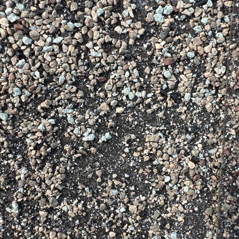 Commercial roofing gravel surface with hail damage