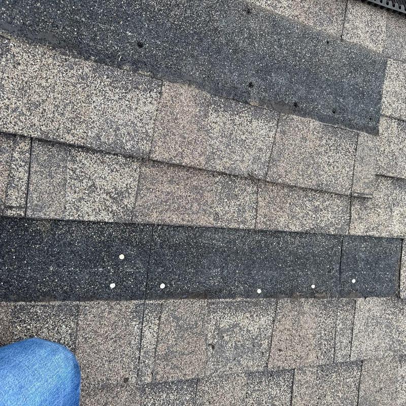 Asphalt shingle roof with nail pattern and wear marks