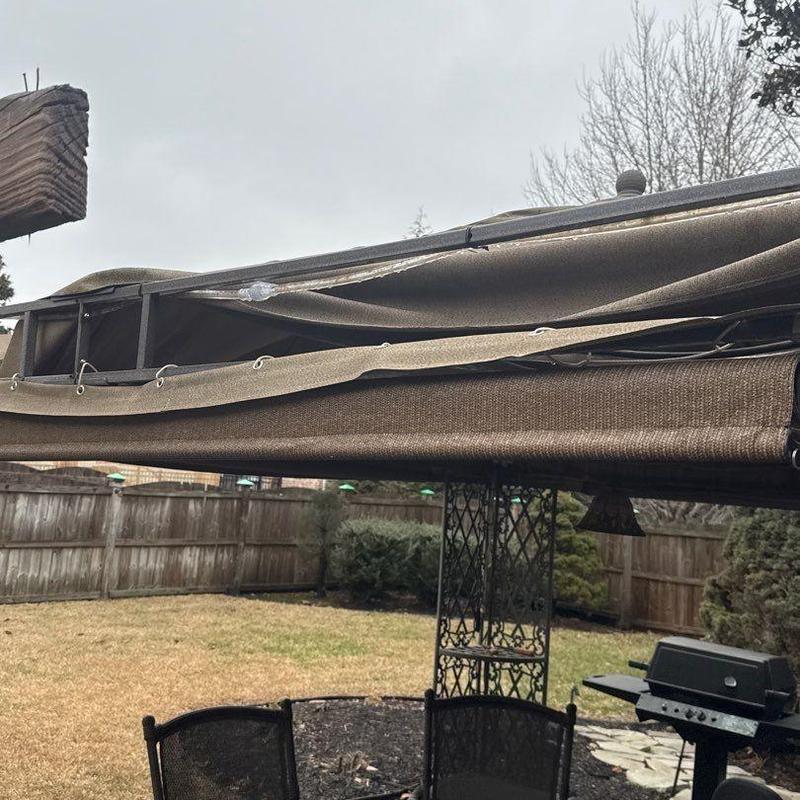 Awning fabric with tear damage and metal frame