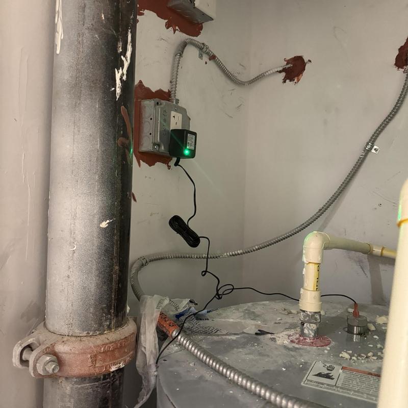 Power anode rod installation on water heater in utility room