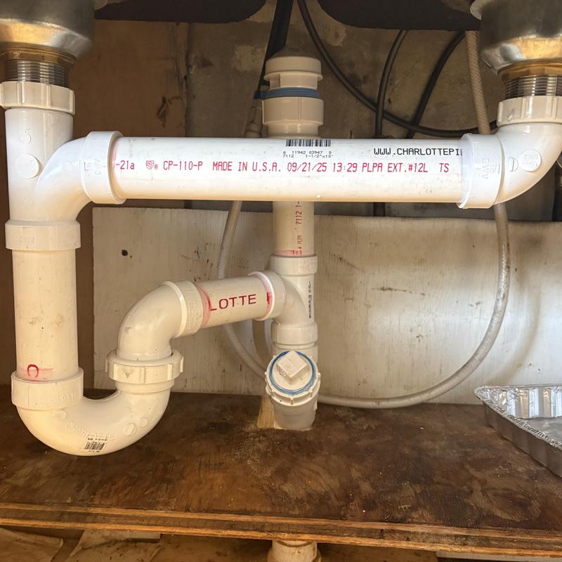 PVC drain pipes under kitchen sink with new strainers