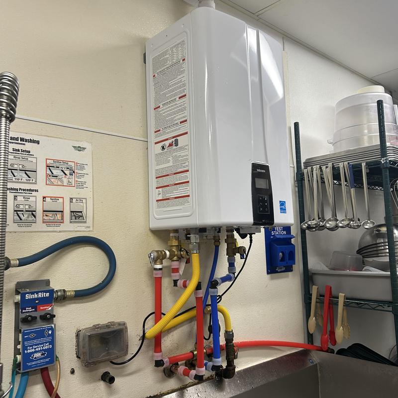 Tankless water heater with plumbing connections