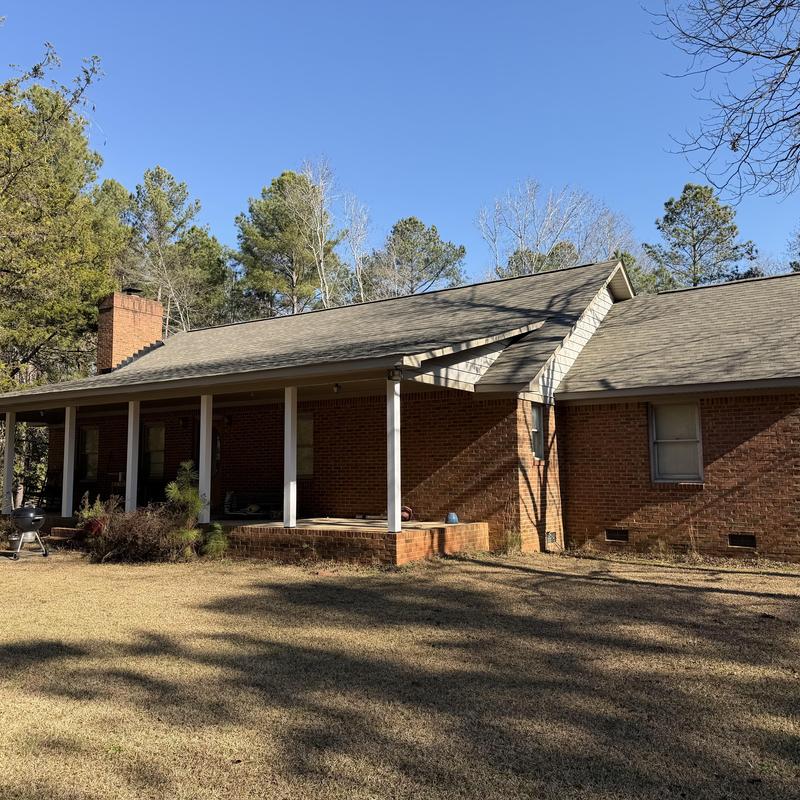 Asphalt shingle roof with new fascia on brick house