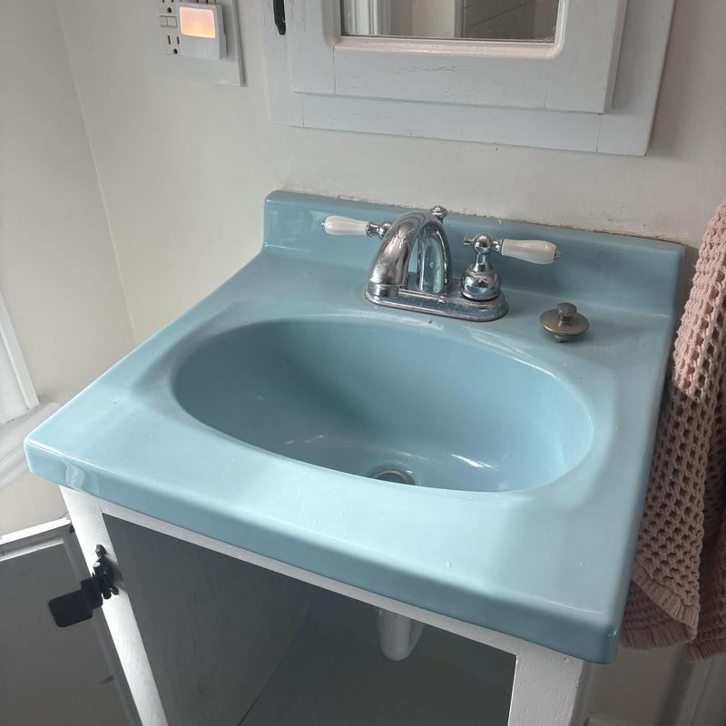 Lavatory sink drain with chrome faucet and cabinet open