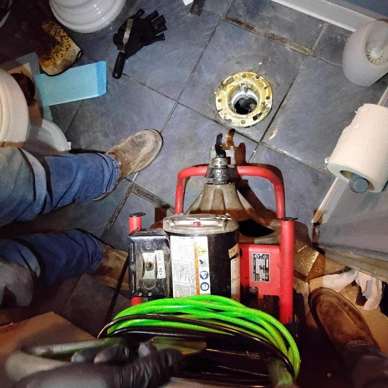 Toilet flange and drain cable clearing stoppage in bathroom