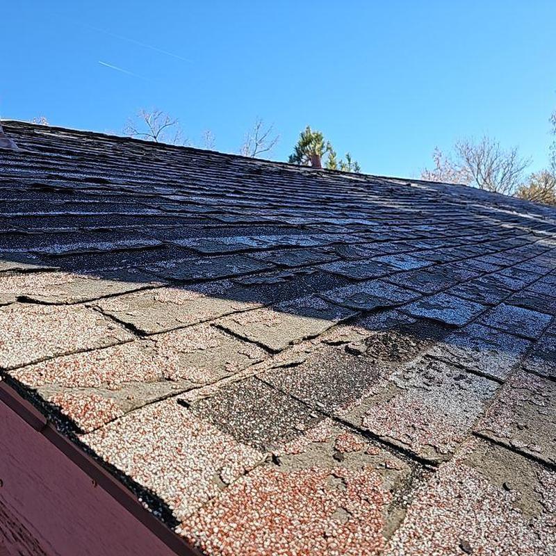 Aged shingle roof with hail damage and deterioration