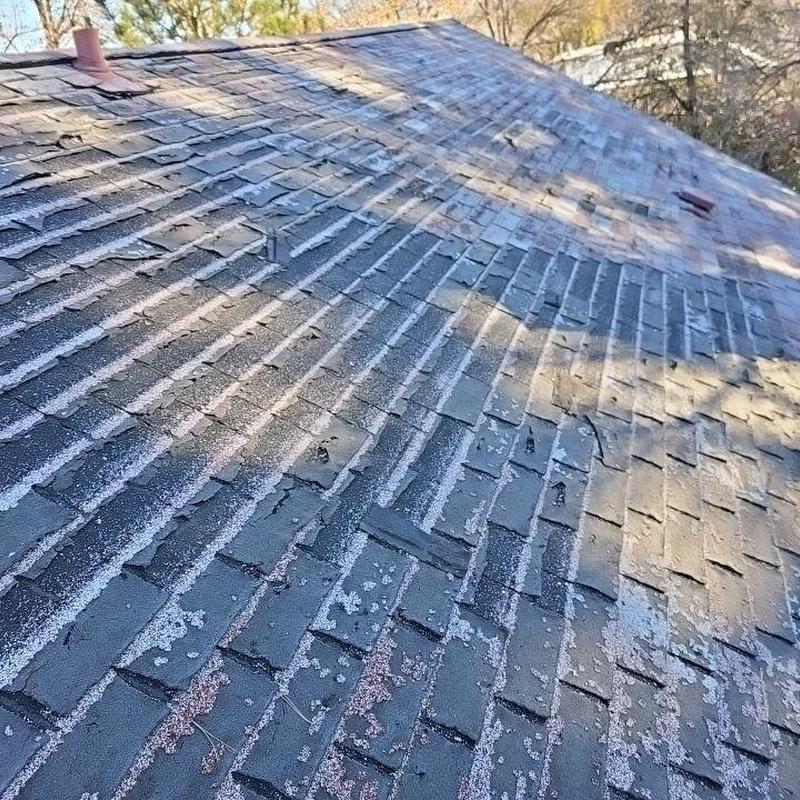Shingle roof with hail damage and aged deterioration