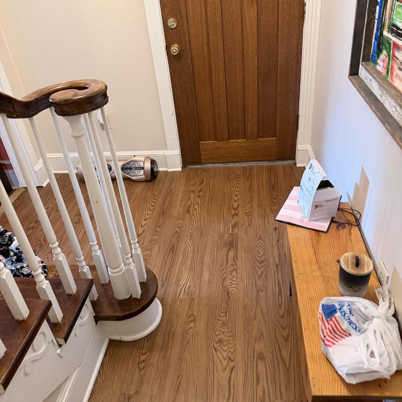 Wood floor demo near entry door and staircase Wood floor demo near entry door and staircase