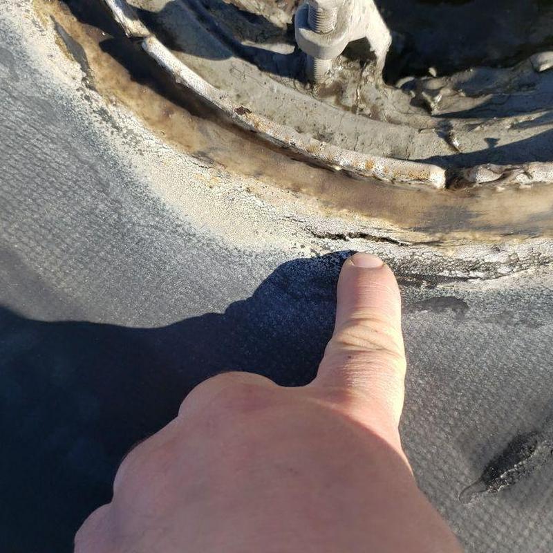 Roof drain seal deterioration on flat roof surface