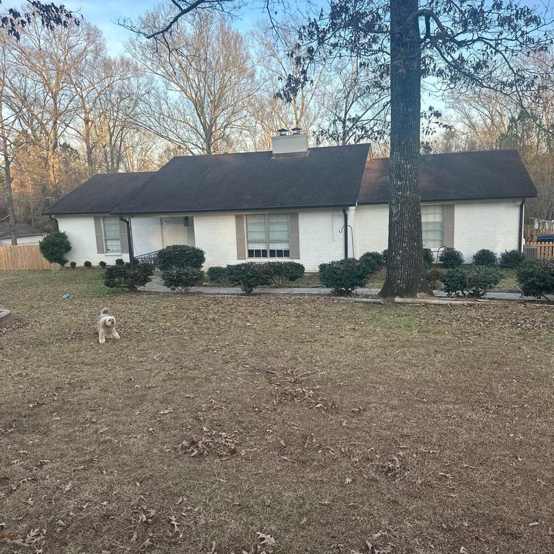 Residential roof exterior with chimney and gutters in Florence, MS