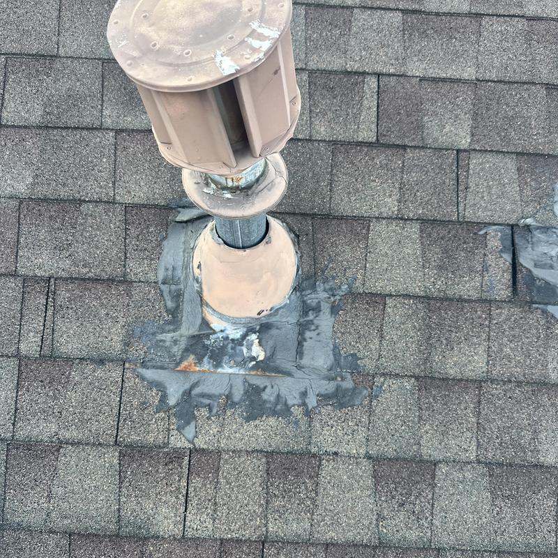 Roof vent with patched shingle flashing on asphalt roof