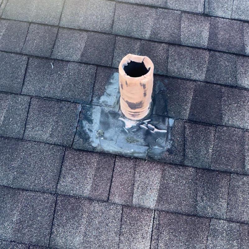 Roof vent pipe with patched flashing on shingles