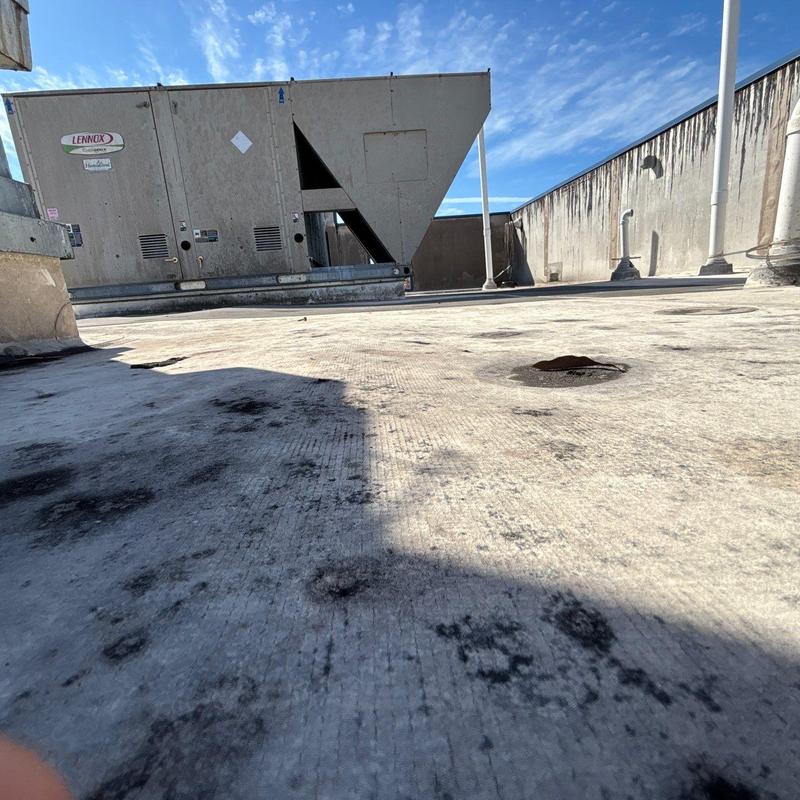 Commercial roof surface with hail damage and drainage points