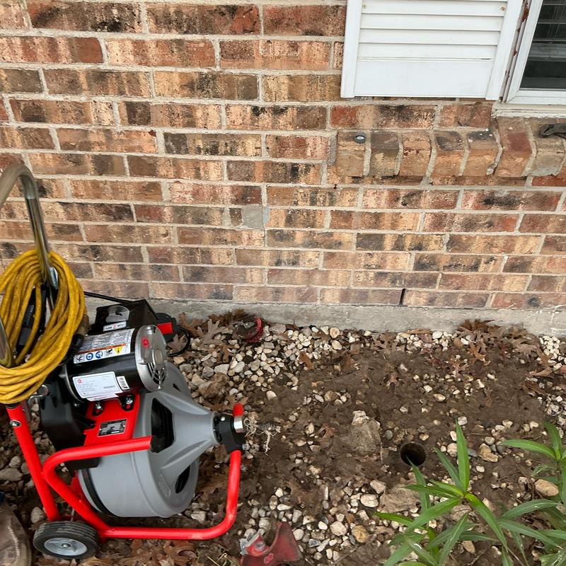 Clay sewer line with root infestation and drain cleaning machine