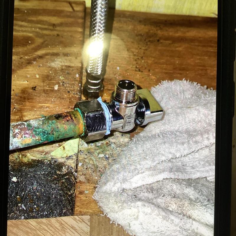 Brass angle stop valve installed on corroded pipe