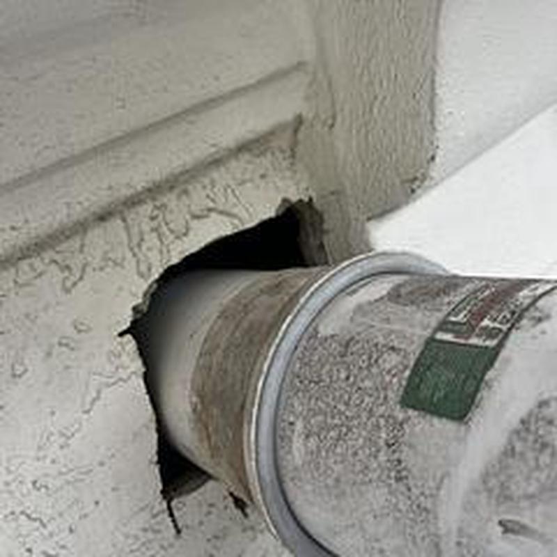 Concentric vent pipe improperly fitted through wall hole