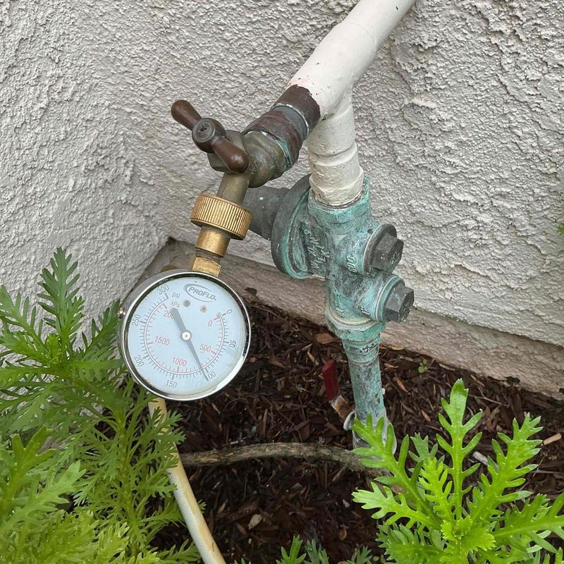 Water pressure gauge on outdoor pipe system