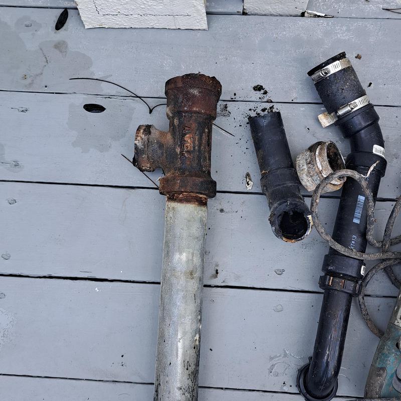 Vertical kitchen drain pipe and fittings removed on floor Vertical kitchen drain pipe and fittings removed on floor