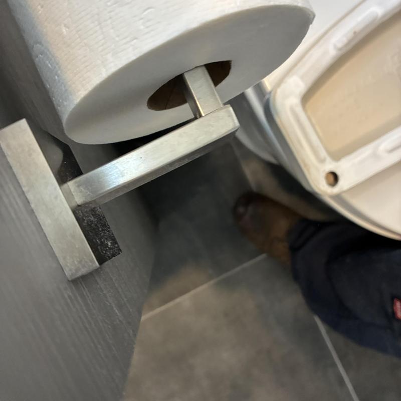 Toilet paper holder installation in bathroom corner