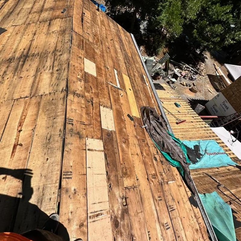 Plywood roof decking installation with dry rot patches