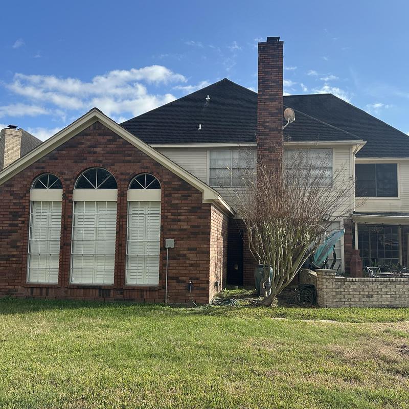Asphalt shingle roof with chimney and storm damage Asphalt shingle roof with chimney and storm damage
