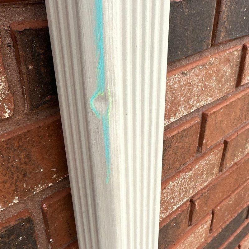 Gutter downspout dent marked for hail storm damage Gutter downspout dent marked for hail storm damage