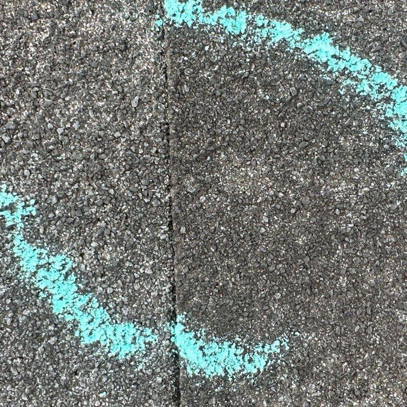 Asphalt shingles with hail damage marked in blue Asphalt shingles with hail damage marked in blue