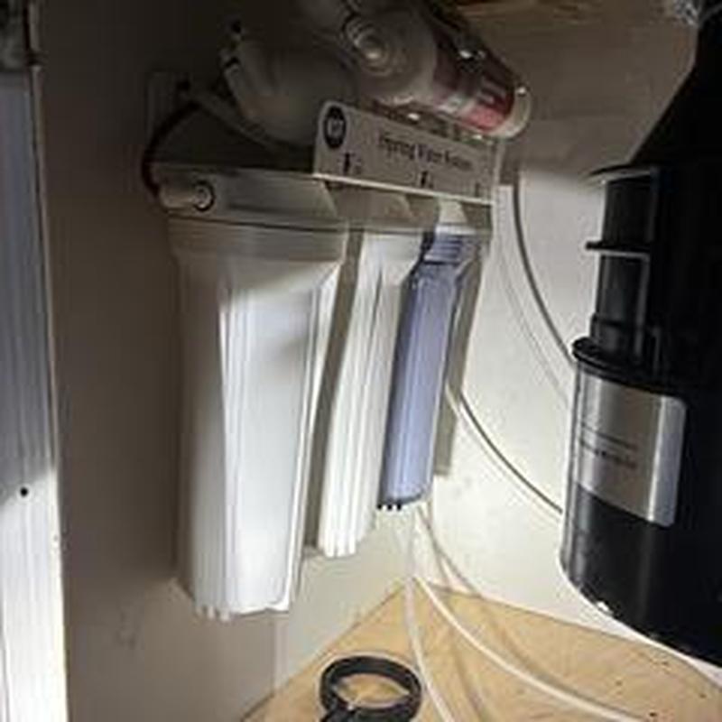 Reverse osmosis water filtration system installation under sink