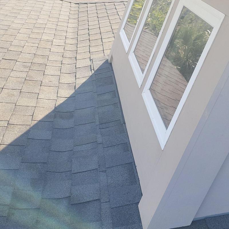 Owens Corning shingles on residential roof near windows Owens Corning shingles on residential roof near windows