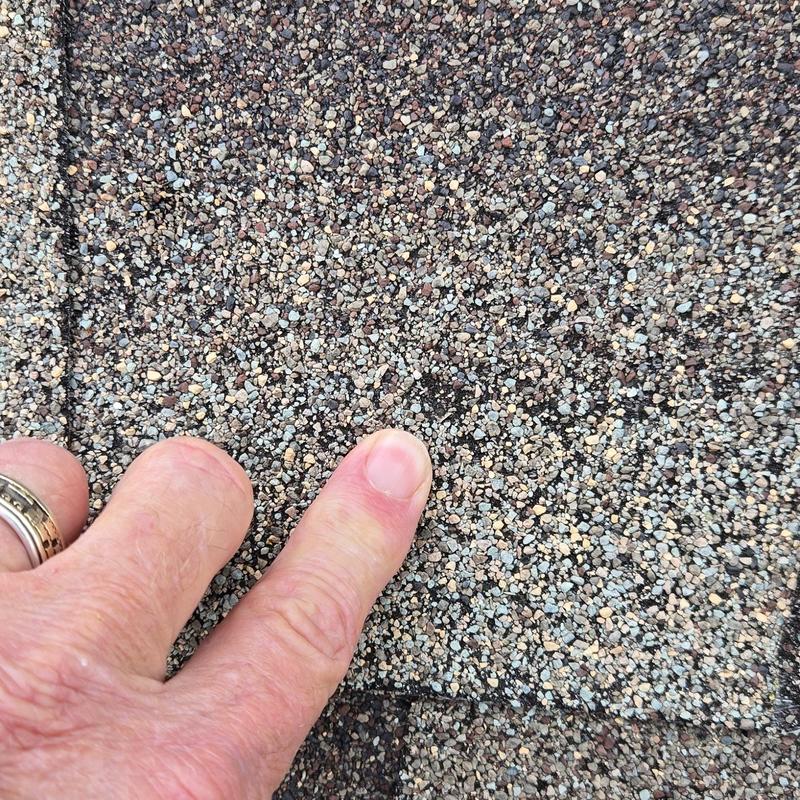 Asphalt shingle granule loss indicating potential leak risk