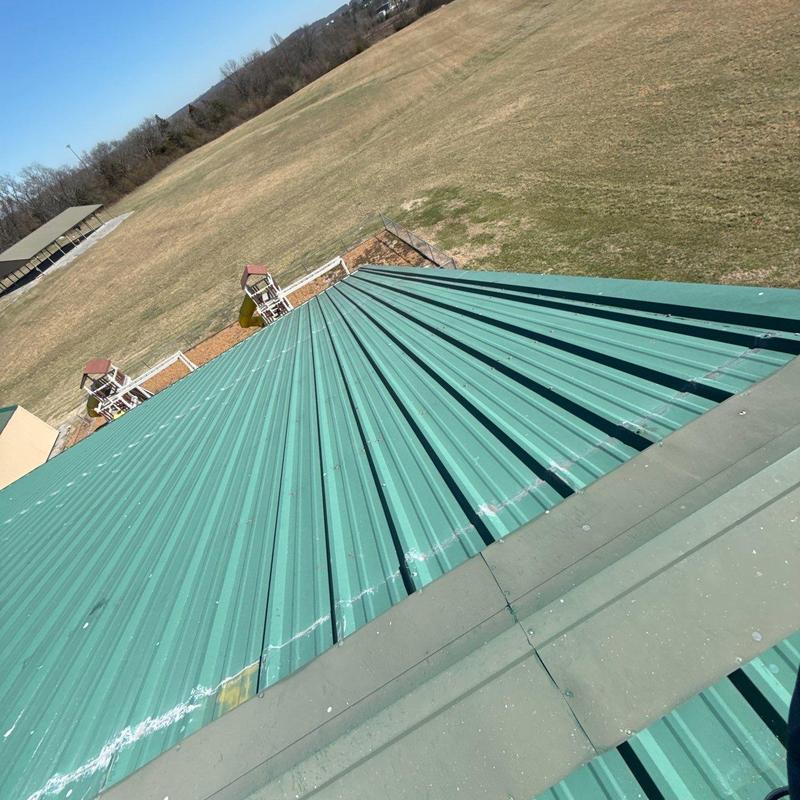Metal roofing panels with hail damage and flashing