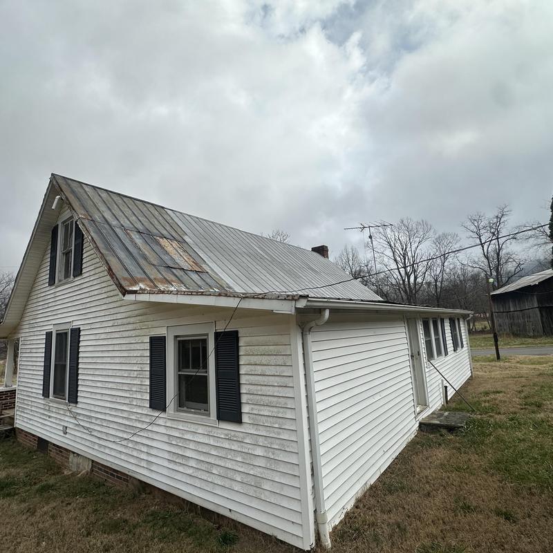 Metal roof with rust and patch on residential house