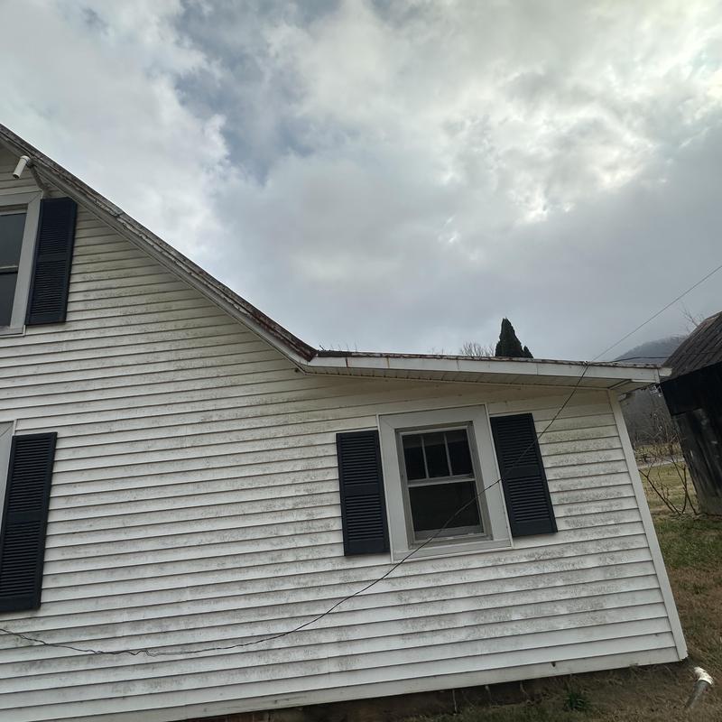 Metal roof edge and gutter on white house