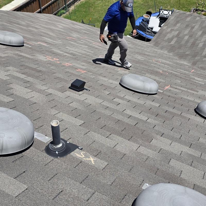 Asphalt shingle roof with hail damage inspection