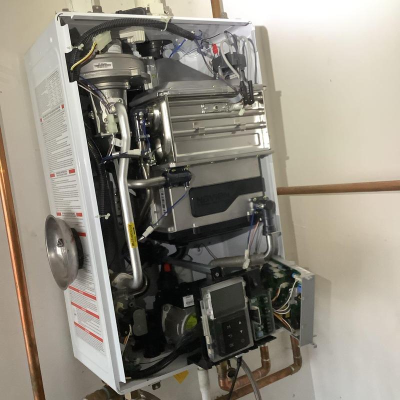 Tankless water heater internal components exposed